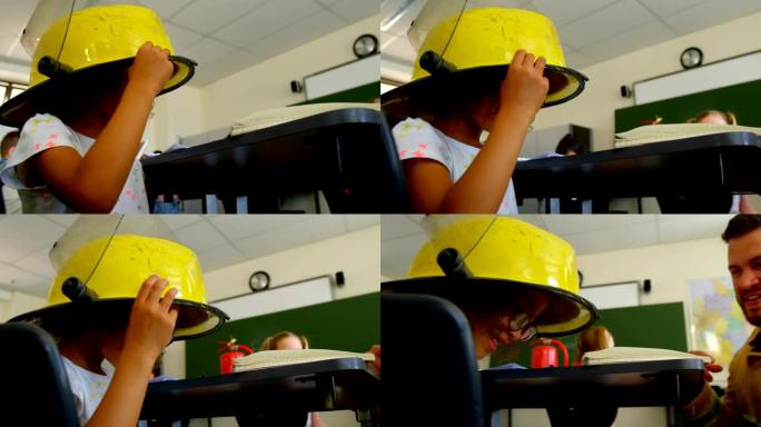 4k学校教室里戴着消防员头盔的女学生