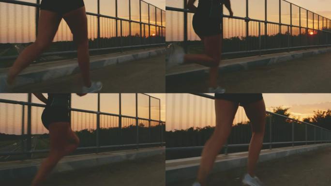 日落时分，一个女人在桥上奔跑的SLO MO腿