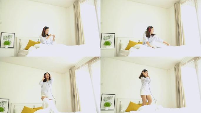 慢动作; 亚洲女孩戴着耳机听音乐，在卧室跳舞。