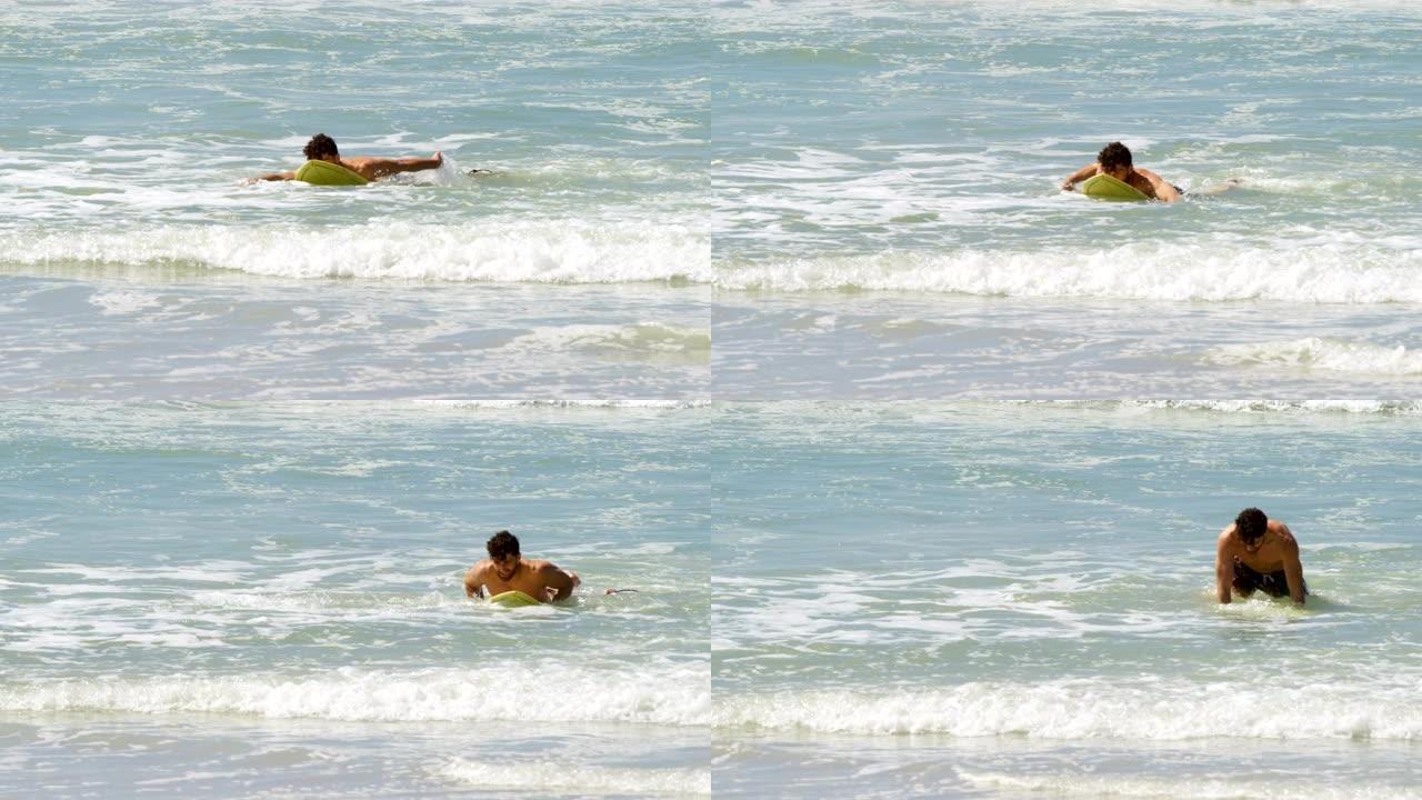 男性冲浪者在4k海滩用冲浪板在海里冲浪