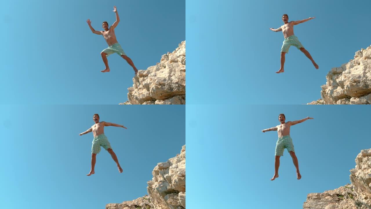 慢动作: 在克罗地亚快乐的男性游客悬崖跳水的电影拍摄。