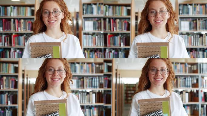 大学图书馆里拿着书的学生漂亮女孩的肖像微笑