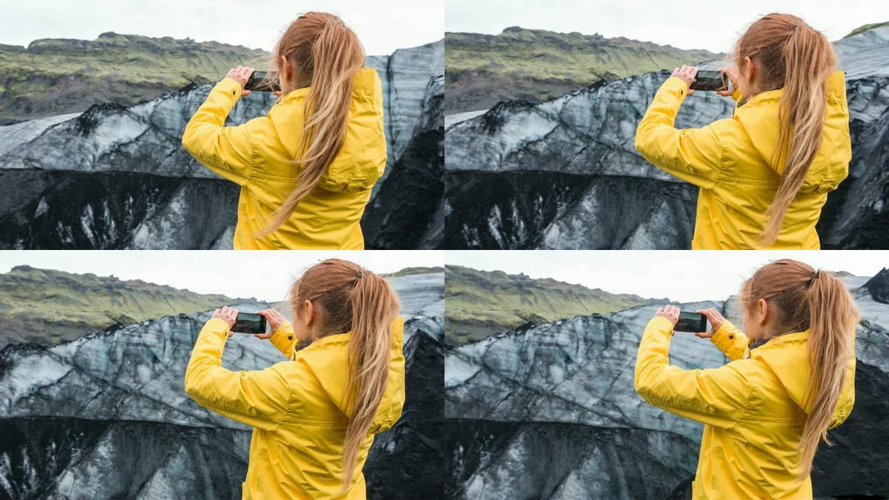 用智能手机拍摄冰岛冰川覆盖火山灰的女人