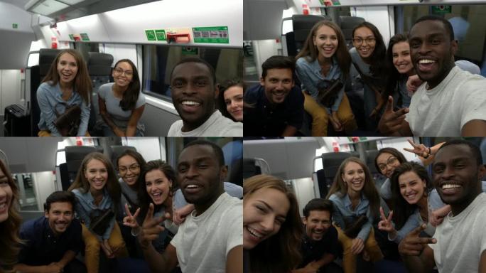 在火车上通勤的朋友组成的多元化团体自拍，使面孔微笑