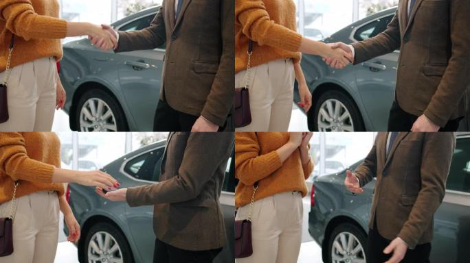 握手时男女手的慢动作，女士从经理那里拿钥匙