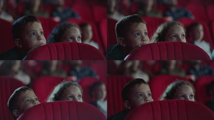男孩和女孩躲在电影院的座位后面