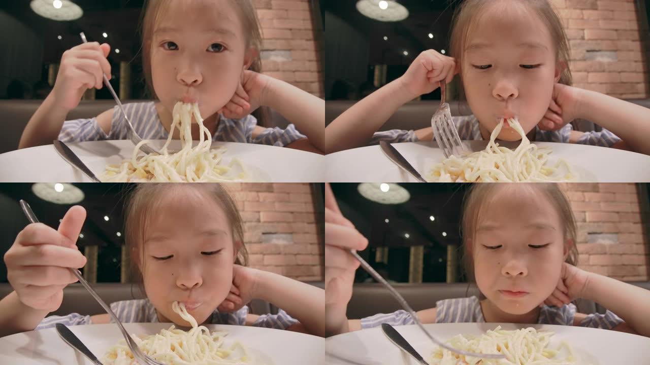 小女孩在吃美味的意大利面。