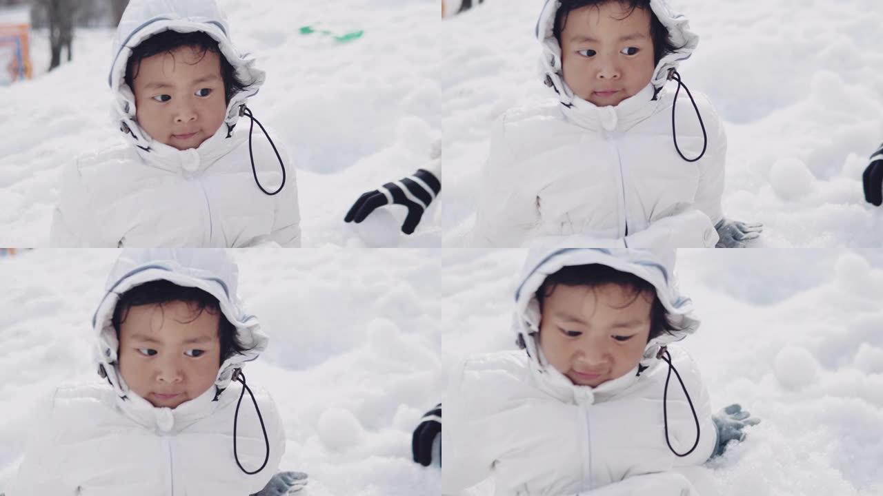 学龄前男孩在雪地里玩耍