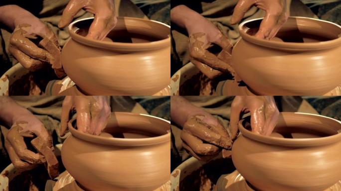 陶工在转动轮子上的花瓶时使用海绵。4K。