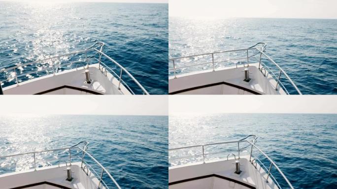 在晴朗的夏日，白色邮轮游艇鼻子在海浪上航行到阳光明媚的开阔海面的美丽景色。