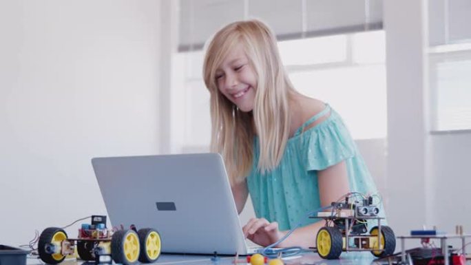 课后计算机编码课女学生构建和编程机器人车辆