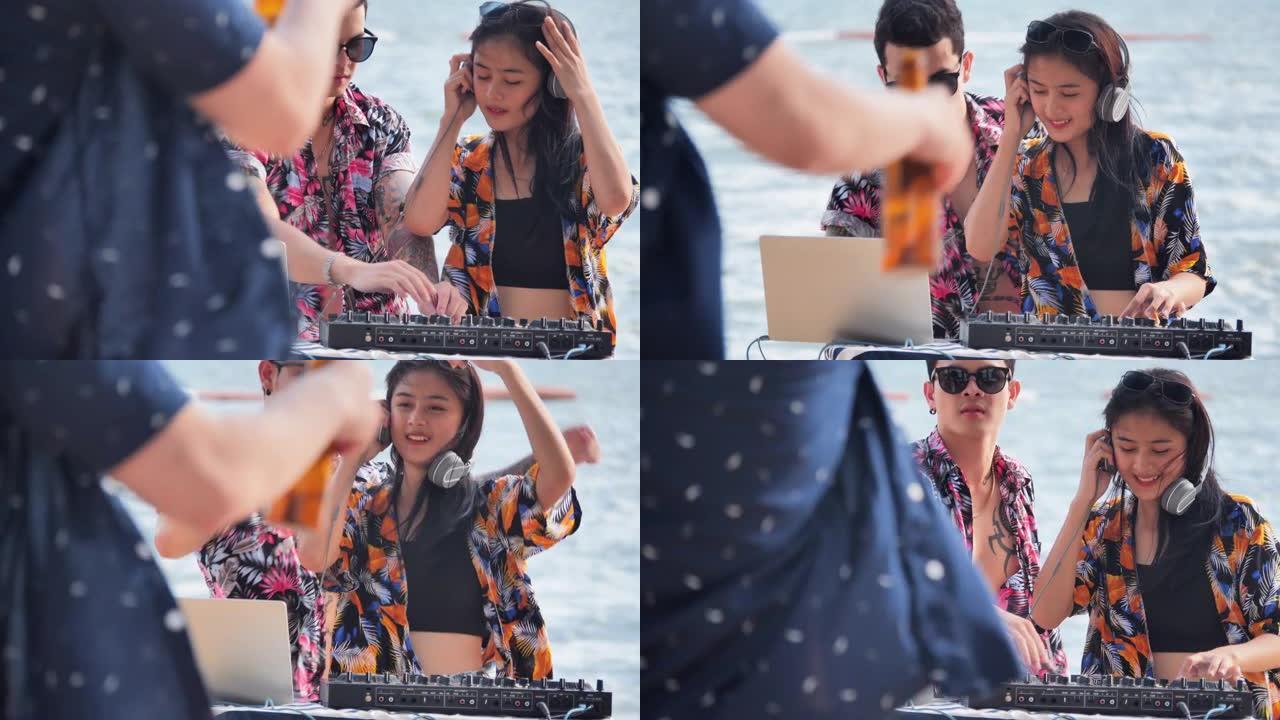 夏季度假户外海滩派对上的Dj混音。DJ为人群播放和混音音乐。DJ在乙烯基和调音台上的手。假期-iSt