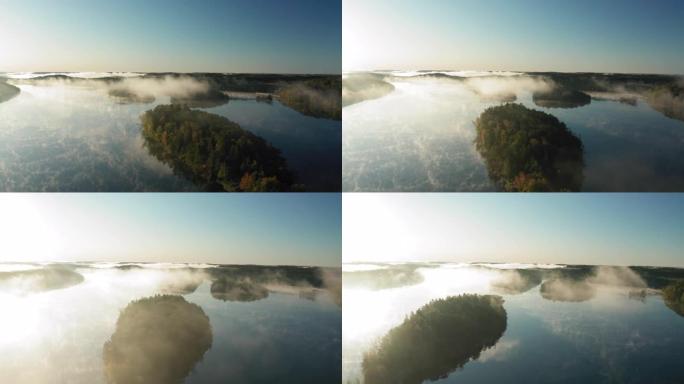 在秋天的早晨，被美丽的薄雾覆盖的湖泊的鸟瞰图