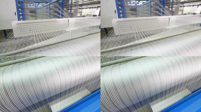 一串白线正在迅速重新定位。纺织厂设备。