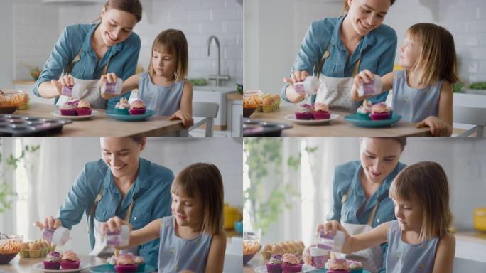 在厨房里: 母亲和可爱的小女儿在奶油蛋糕糖霜上撒上Funfetti。一家人一起煮松饼很开心。可爱的孩
