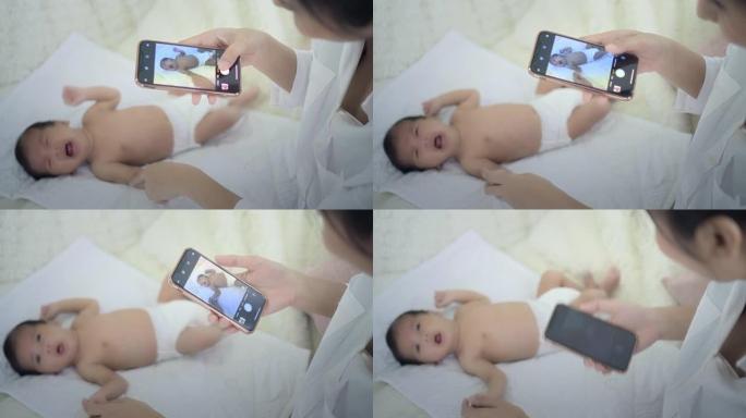 妈妈给男婴拍照给男婴拍照