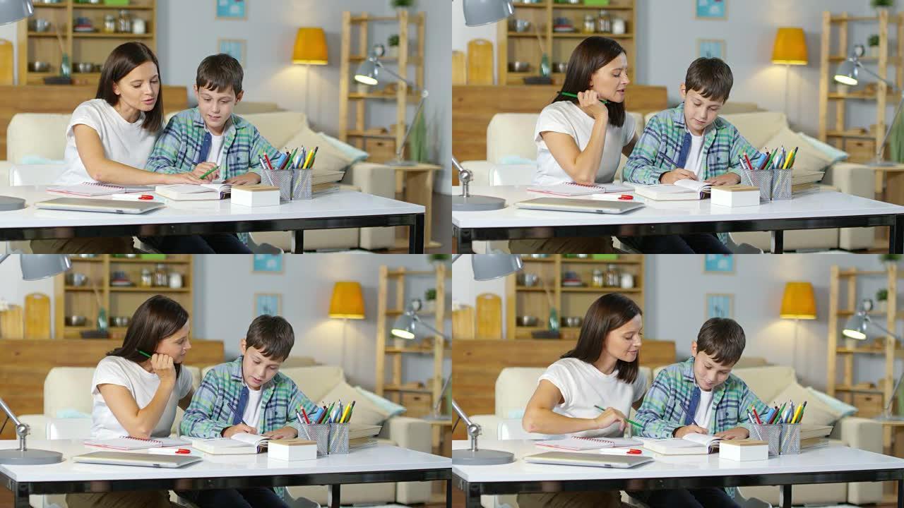 男孩和漂亮的妈妈一起做作业