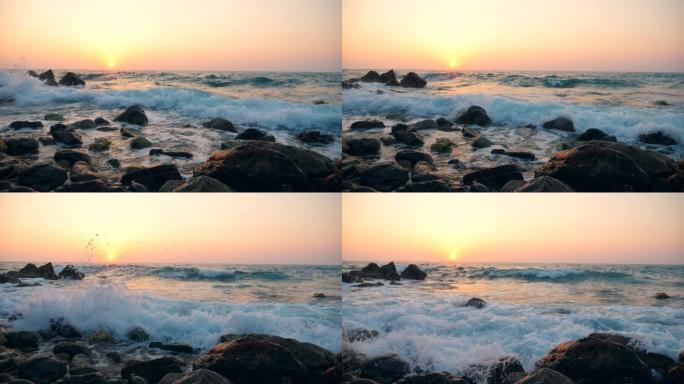 白浪在日落背景上撞击海岸线，慢动作。