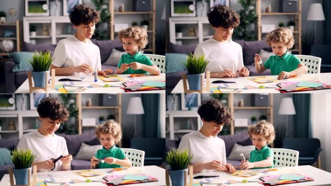 小男孩和他妈妈用胶水做拼贴画剪纸图