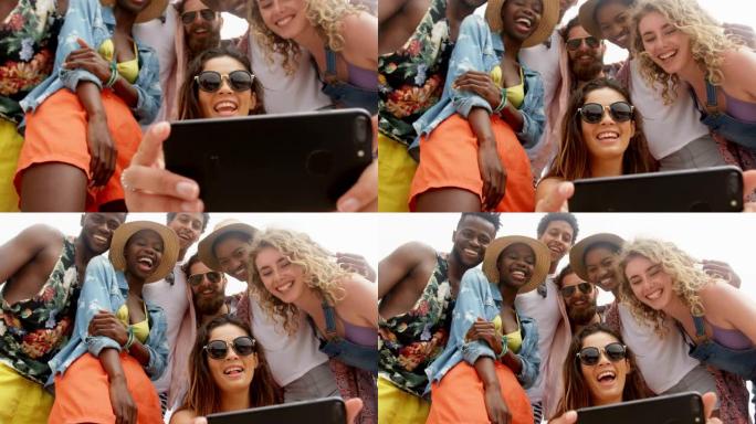 混血朋友在沙滩上用手机自拍的低角度视角4k