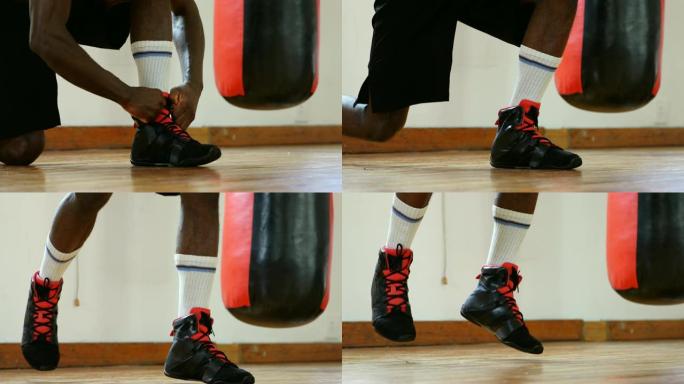 健身室4k男拳击手系鞋带