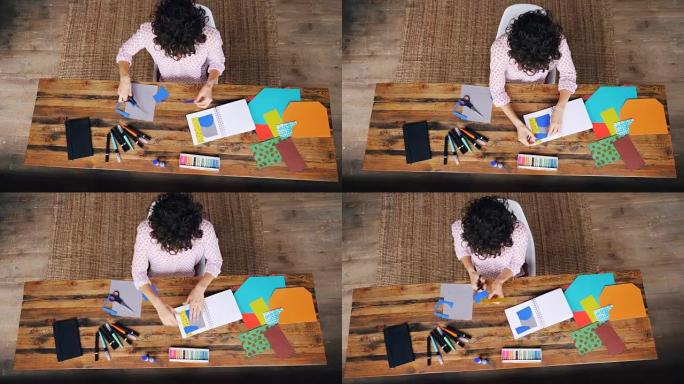 在家庭办公室工作的年轻女士创意设计师的俯视图，用splash-paper cutting人物制作拼贴