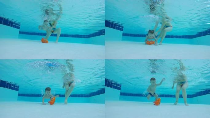 小男孩试图在游泳池里拿玩具，特写镜头。