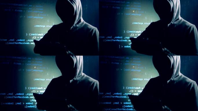 伪装的黑客正在用投影数据在墙旁边操作平板电脑