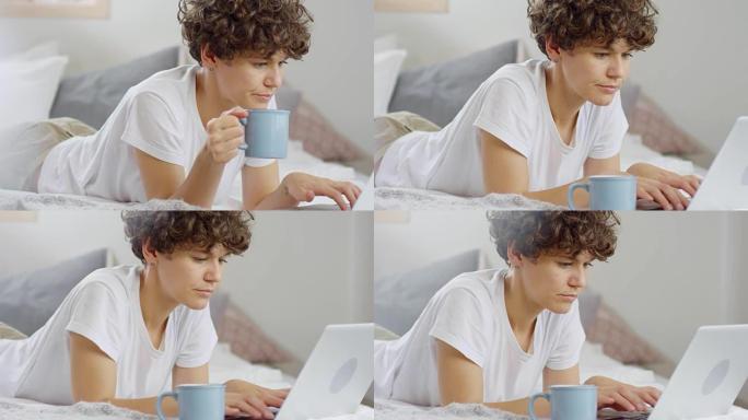 Woman Drinking Coffee and Working from Bed