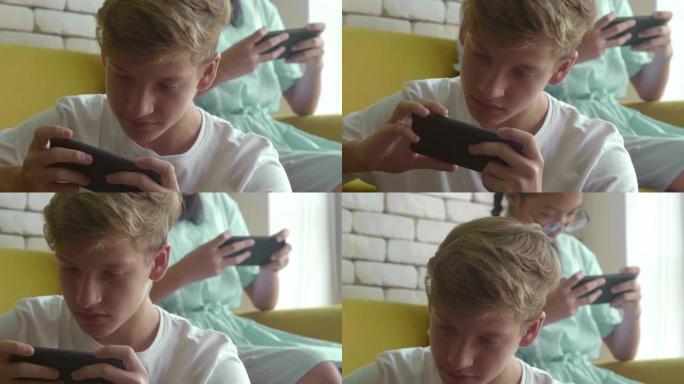 玩智能手机的男孩玩手机打游戏沙发