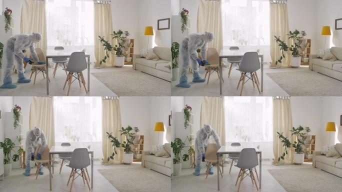 在家穿着防护服消毒椅的女人