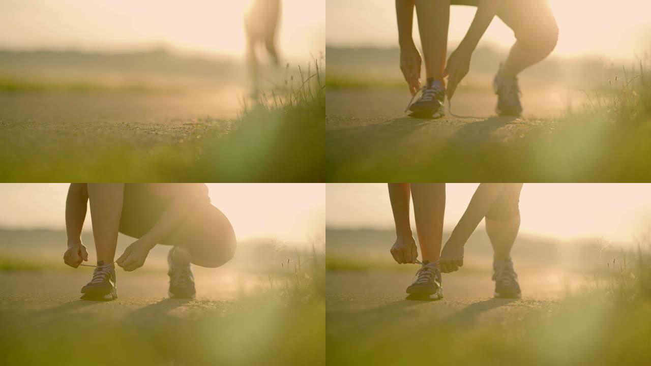 SLO MO女人在日出跑步时系鞋带