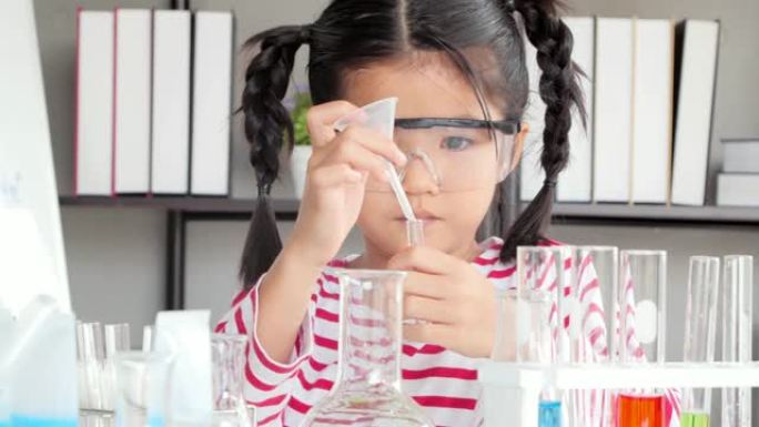 有趣的小女孩在实验室做实验。科学与教育。孩子生命中的一天。教育主题