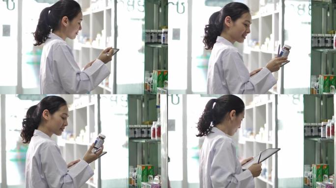 亚洲药剂师使用数字平板电脑在药房工作