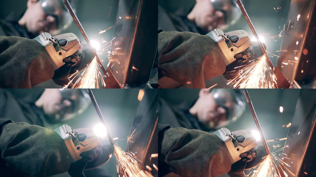 工匠手中的旋转锯正在切割铁