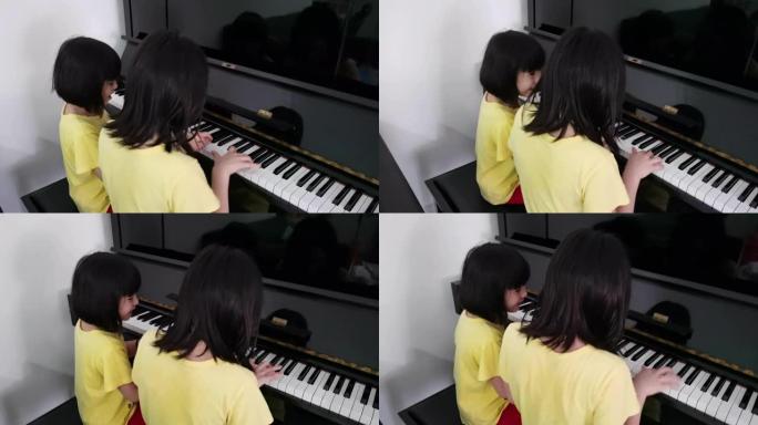 2亚裔华裔少女一起在家玩钢琴取乐