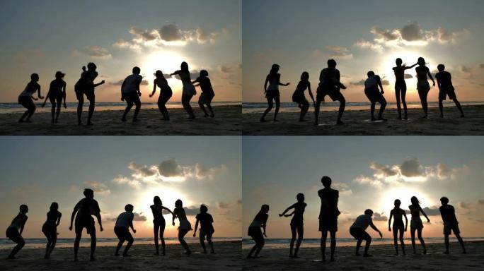 夏天，友谊，大海，暑假，假期和人们概念，假期，在海滩上一起跳跃的微笑朋友的剪影-iStock