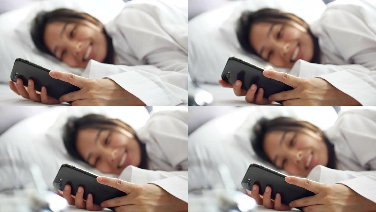 早上床上有智能手机的年轻女子