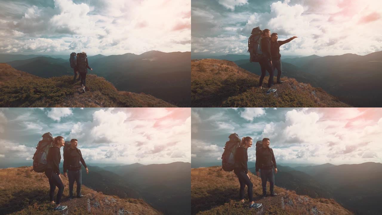 带露营背包的夫妇在山上散步
