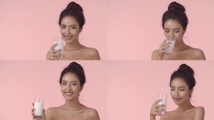 喝牛奶的迷人亚洲女人。