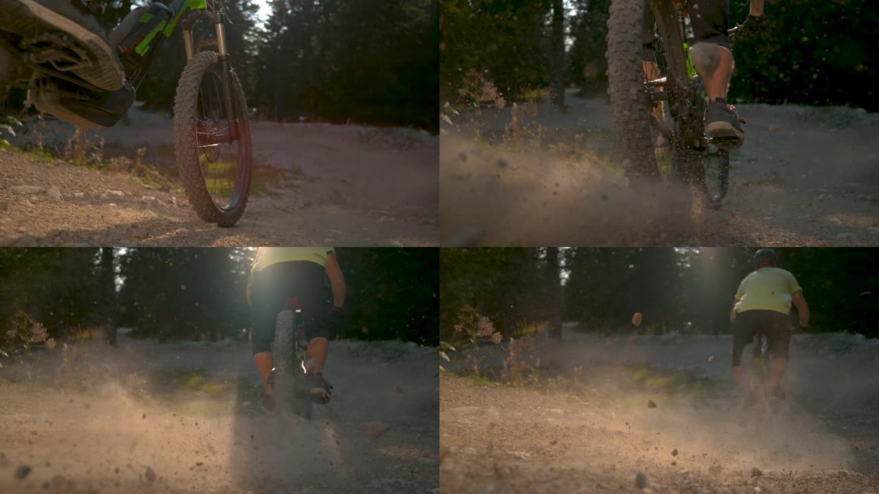 慢动作: 骑山地自行车的人在下坡时扬起灰尘。