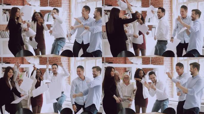 快乐有趣多样的商业团队跳舞扔纸庆祝成功