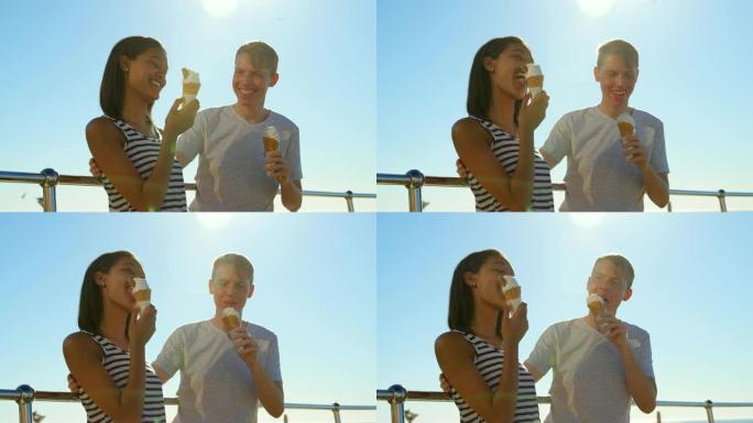 快乐的年轻夫妇在4k栏杆附近吃冰淇淋