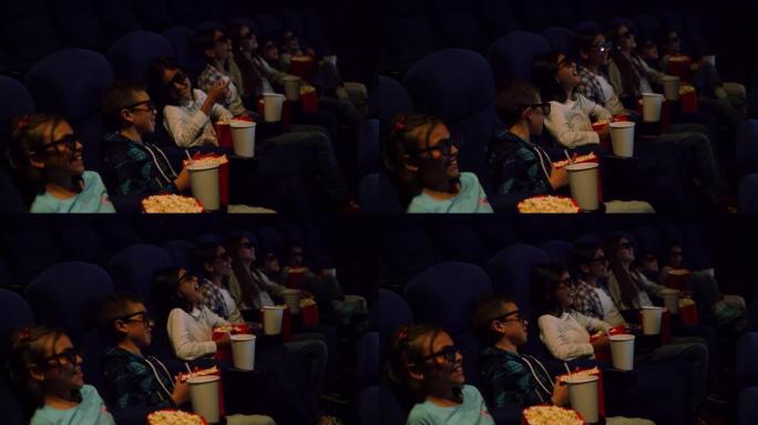 拉丁美洲的一群孩子在电影院里一边欣赏喜剧3D电影，一边享受小吃