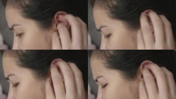 亚洲女性使用智能手机，耳朵发痒