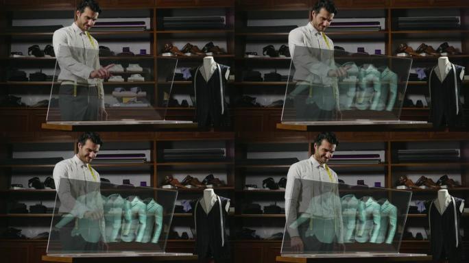 一个裁缝店的男人，他单击玻璃监视器以选择要使用全息术购买的材料和衬衫的类型。
