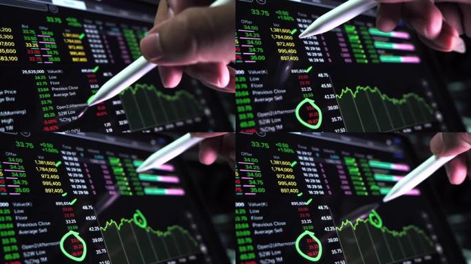 商人在电脑上处理股票市场数据