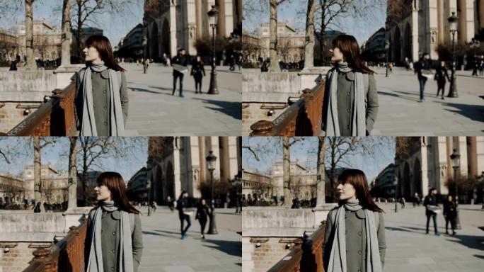 快乐和平的美女独自走在巴黎圣母院广场附近，享受阳光明媚的秋日慢动作。