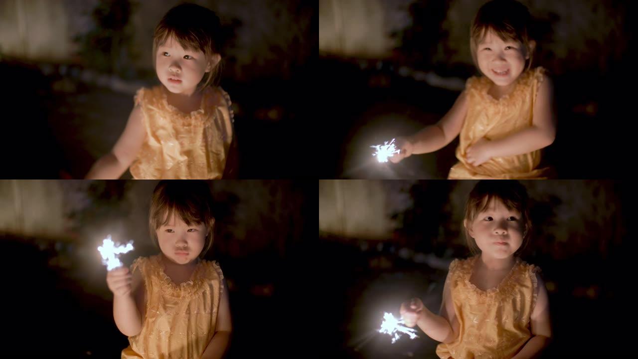 穿着泰国服装的小女孩在loi kathong节上玩烟火