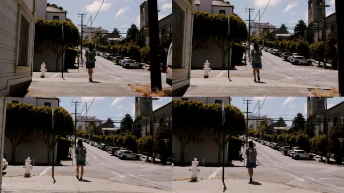 慢动作摄像机跟随快乐的年轻旅游女人带着背包走在夏天旧金山非常陡峭的街道上。